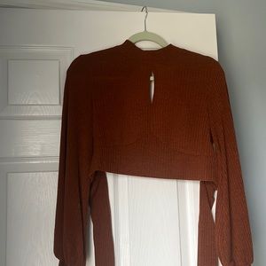 Burnt orange crop top. Ties in the back with Puffy sleeves. Very flattering